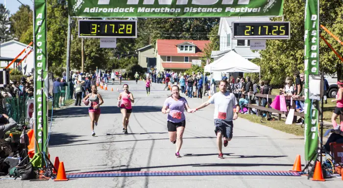 People cross the finish line of a long distance run