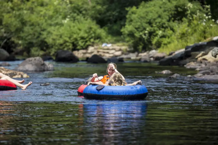 mom and daughter floating down the river