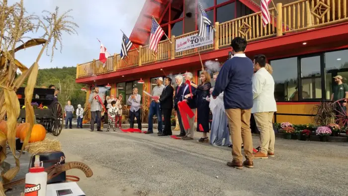 People cutting ceremonial red tape