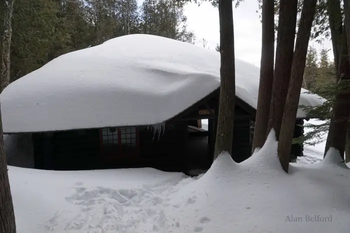 The boathouse had a heavy load of snow.