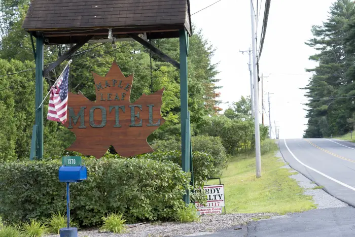 A wooden maple leaf sign for Maple Leaf Motel.