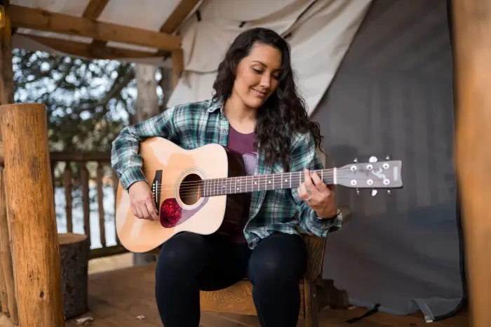 woman playing the guitar