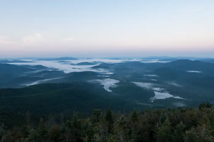 The valleys filled with fog in the early morning sunlight.