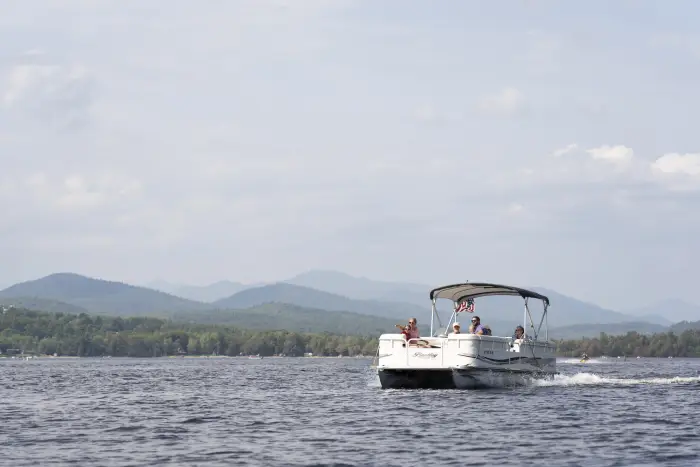 A family has fun on a pontoon boat.