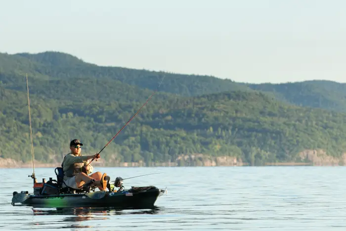Man fishing in his kayak on the lake.