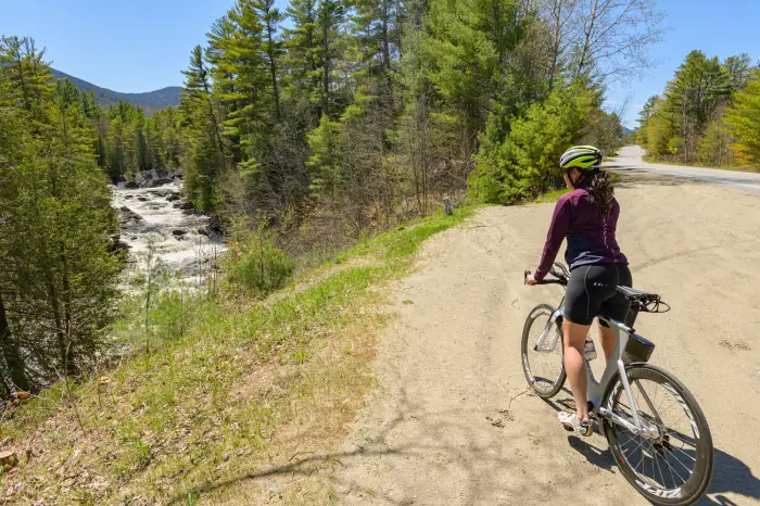 A cyclist views Blue Ridge Falls from the gravel pull-off on Blue Ridge Road