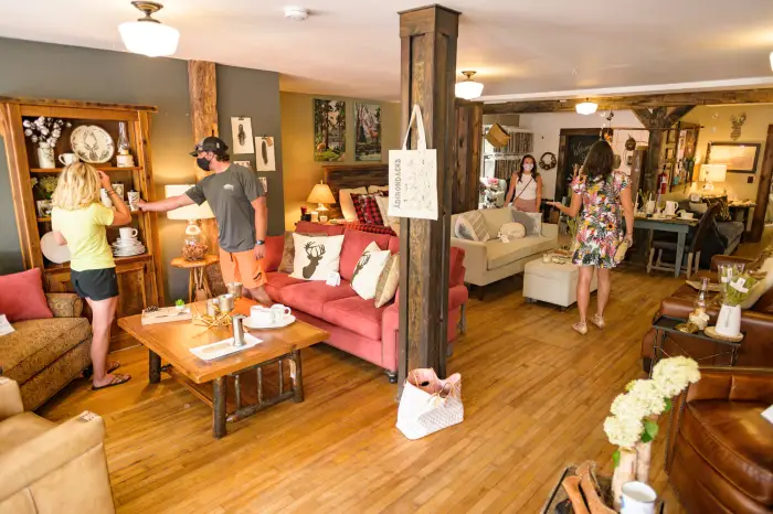 The interior of a cozy home decor and furniture store filled with Adirondack and rustic touches.