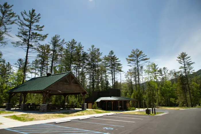 Picnic tables and restroom facilities stand close to the parking lot of the Frontier Town Campground
