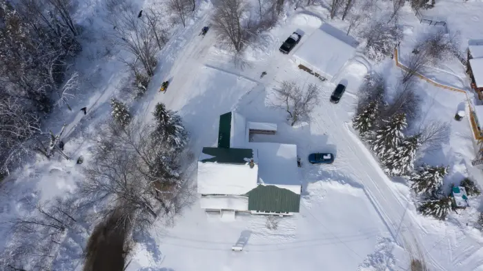 an aerial view of the Inn at Santanoni in snow.