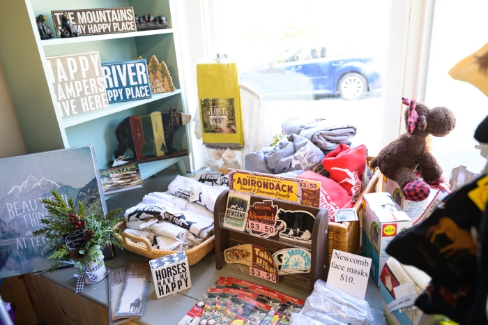 Adirondack-themed gifts fill a sunlit shop window.