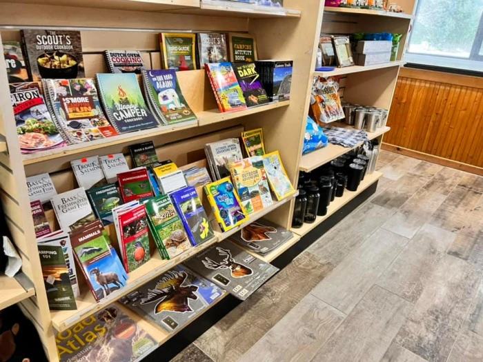 Shelves of Adirondack and outdoor-themed maps and books in a shop.