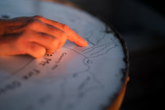 A man points to a spot on a map.