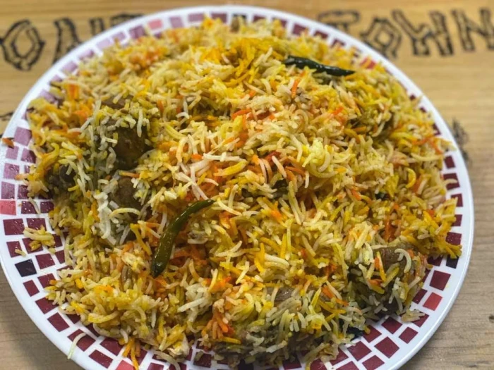 A plate of chicken&#44; rice&#44; and vegetables.