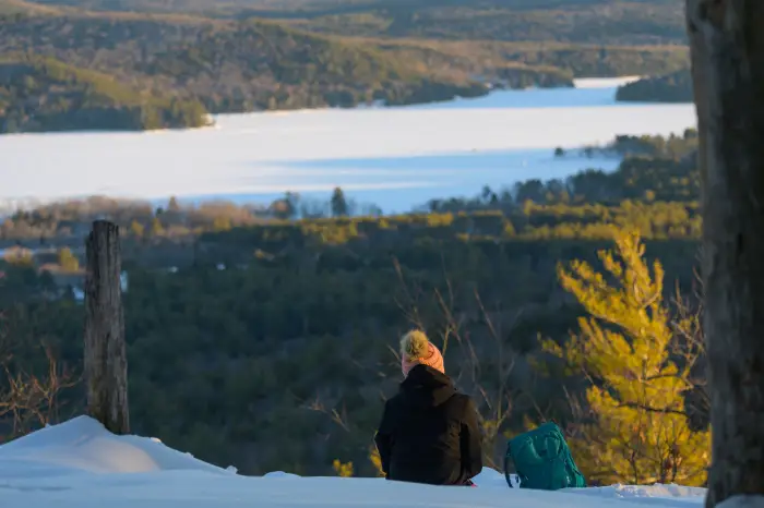 A snowshoer taking in winter views