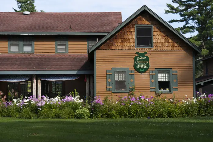 The exterior of a two-story cabin advertising lakefront cottages.