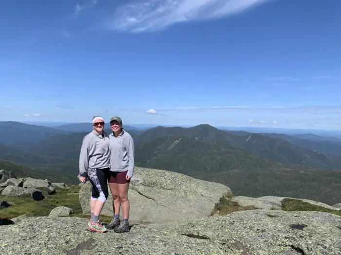 two woman atop marcy mountain