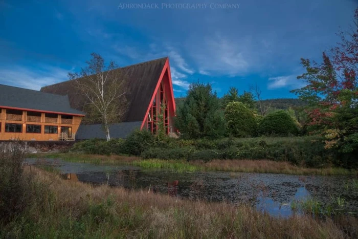 The exterior of Frontier Town&#44; an A-frame building&#44; at dusk.