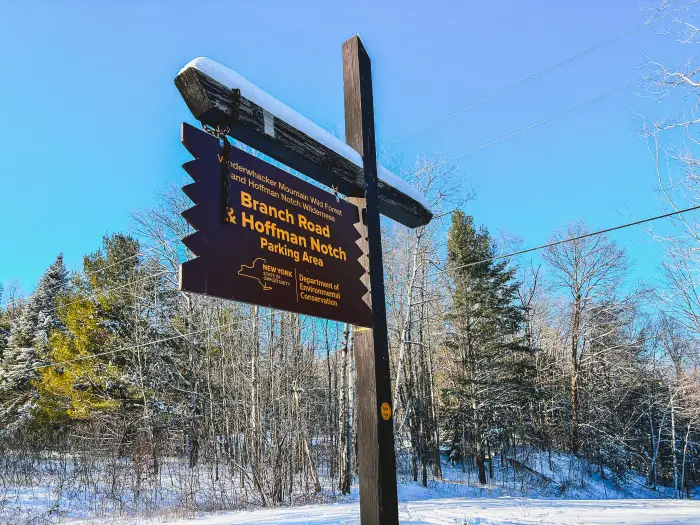 A brown and yellow trailhead sign for the Hoffman Notch Wilderness and The Branch.