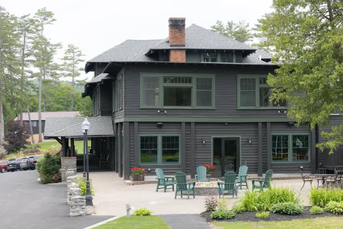 The exterior of a dark brown and green trimmed resort lodge.