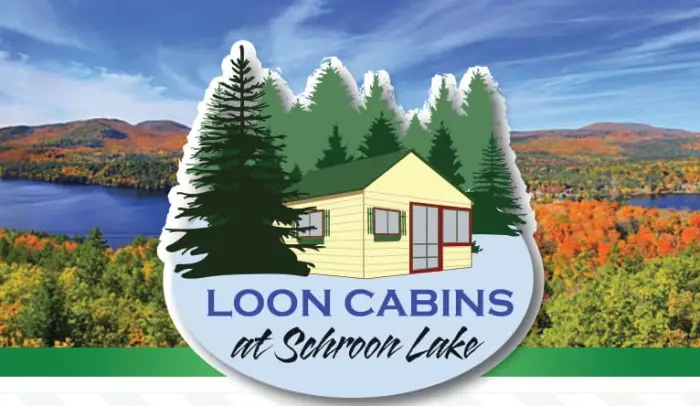 A logo with a white cabin amidst trees with the title: &quot;Loon Cabins.&quot;