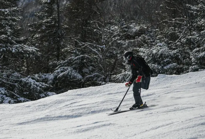 A skier uses outriggers for support and balance