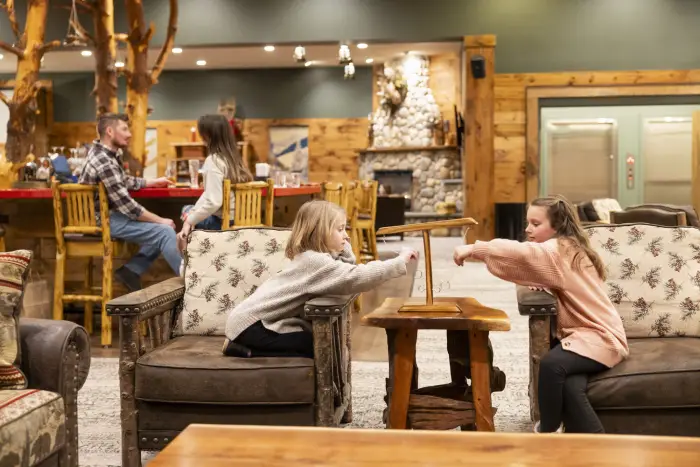 A family in a drinks and relaxing lounge at a lodge