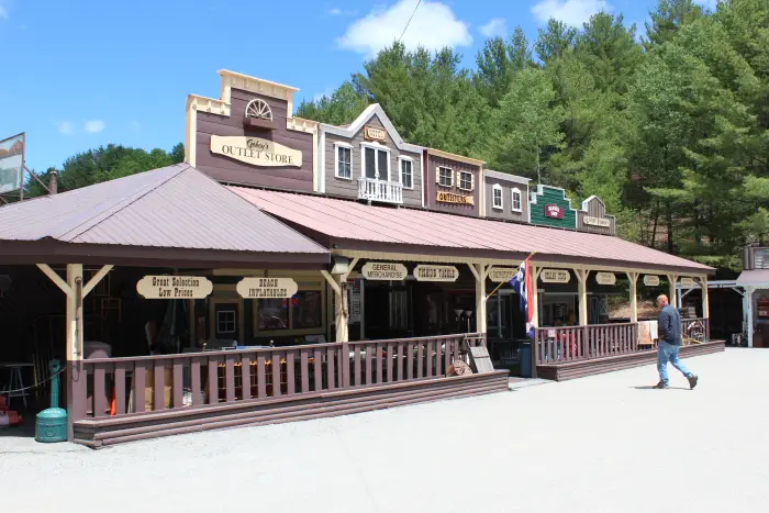 A man walks into a large store themed like an Old West streetfront.