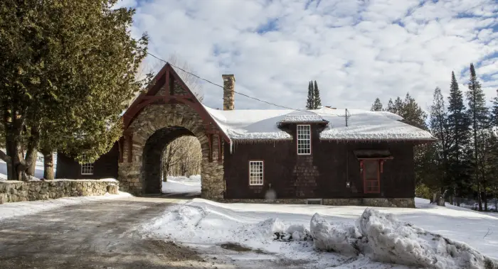 A stone gatehouse in the snow.