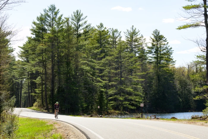 A cyclist rides Longs Hill Road in Minerva