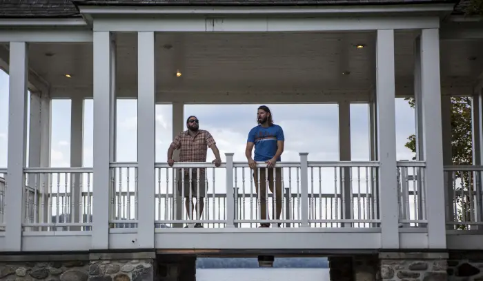 two men stand under the gazebo in Schroon Lake.