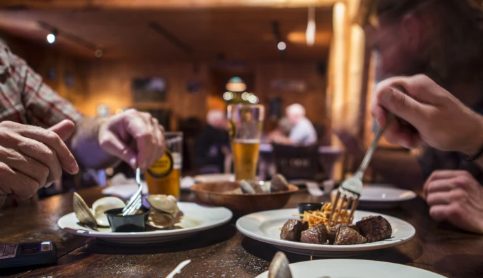 Men enjoying a meal from Sticks and Stones