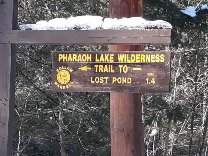 A wooden trail sign that says &quot;Pharaoh Lake Wilderness: trail to lost pond&quot;
