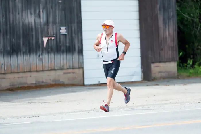 A man runs down a road during a race.