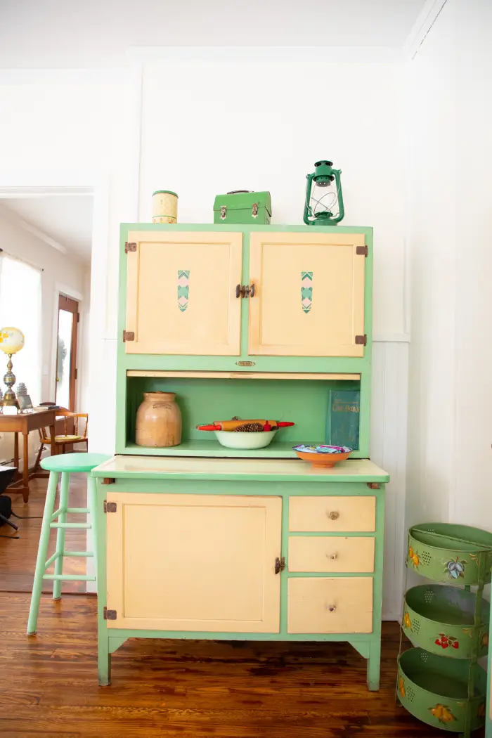 a green and yellow cabinet with outdoor decorations.