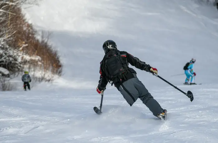 A skier uses outriggers for support and balance