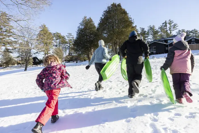 A family heading of a sledding slope