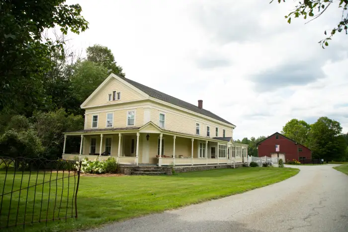 An elegant Victorian farmhouse at the entrance to a cabin rental business.